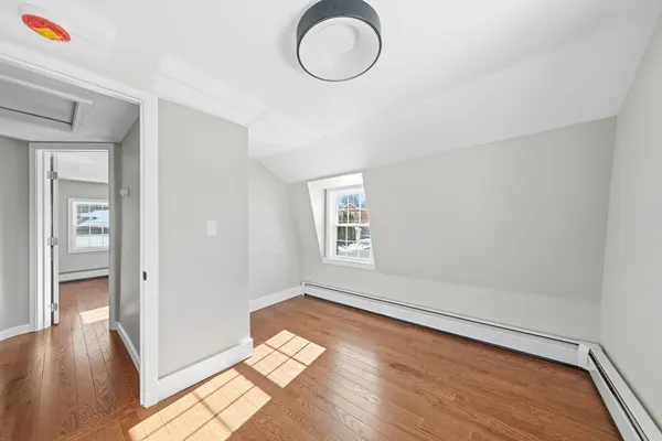 a view of room with window and wooden floor