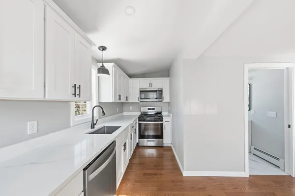 a kitchen with stainless steel appliances granite countertop a sink and cabinets