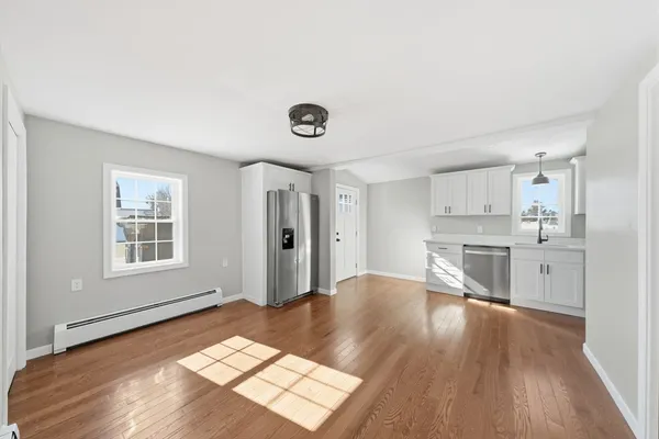 a view of kitchen with granite countertop cabinets and wooden floor