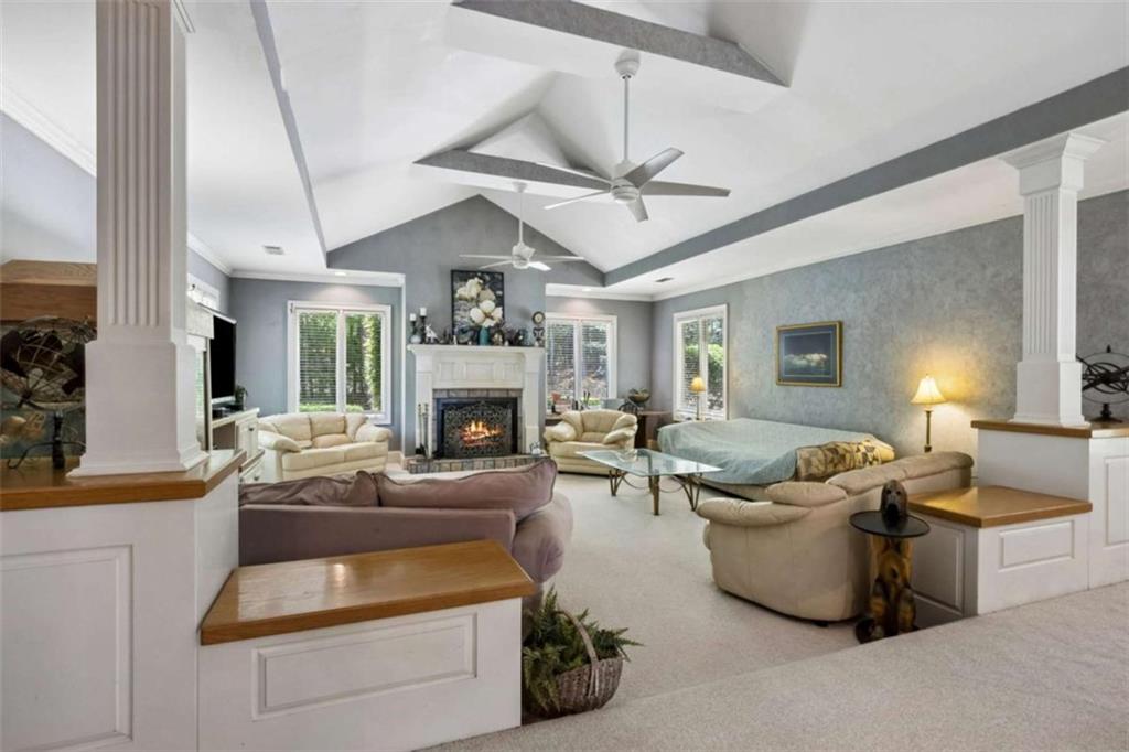 4751 Bill Cheek Road Auburn, GA 30011 - Photo 18 of 82 a living room with furniture and a fireplace