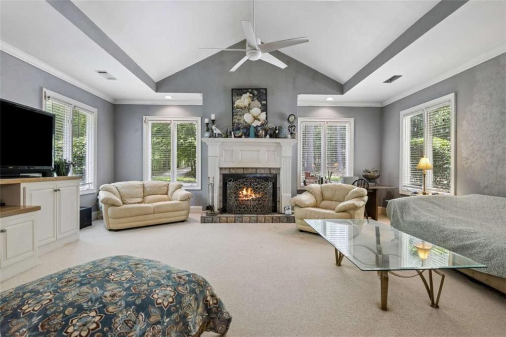 4751 Bill Cheek Road Auburn, GA 30011 - Photo 20 of 82 a living room with furniture a flat screen tv and a fireplace