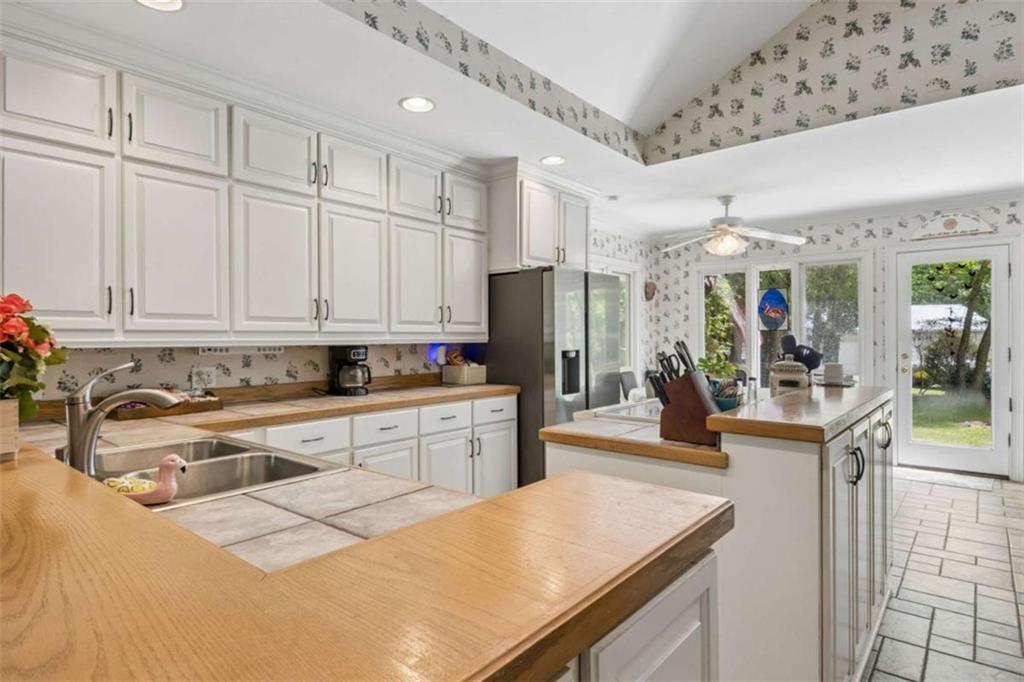 4751 Bill Cheek Road Auburn, GA 30011 - Photo 24 of 82 a kitchen with stainless steel appliances granite countertop a sink refrigerator and cabinets