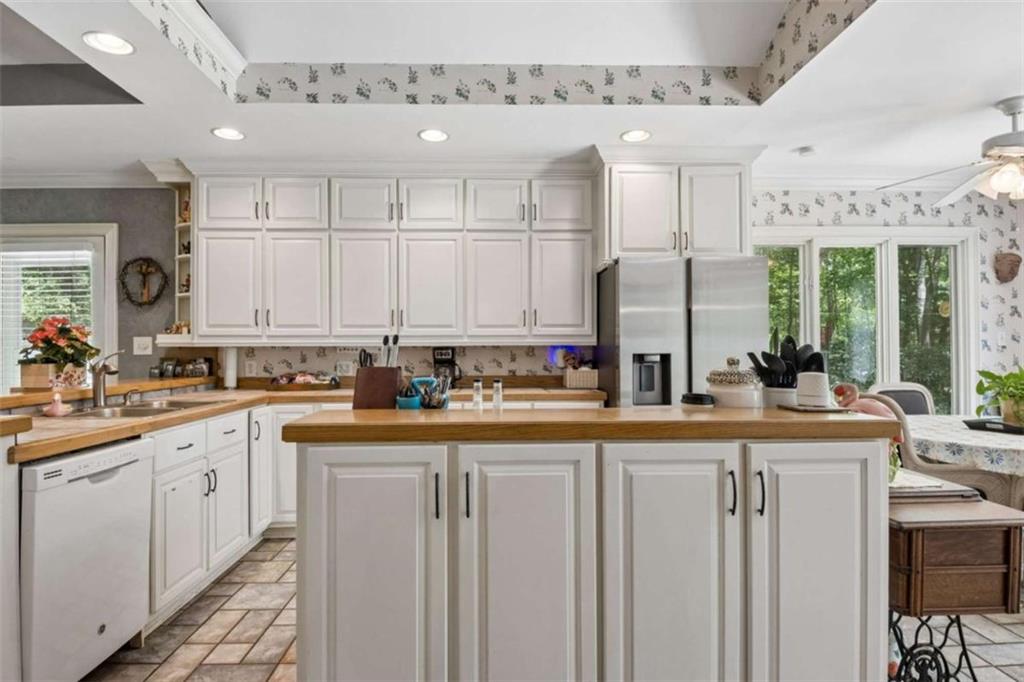 4751 Bill Cheek Road Auburn, GA 30011 - Photo 25 of 82 a kitchen with stainless steel appliances granite countertop a sink and cabinets