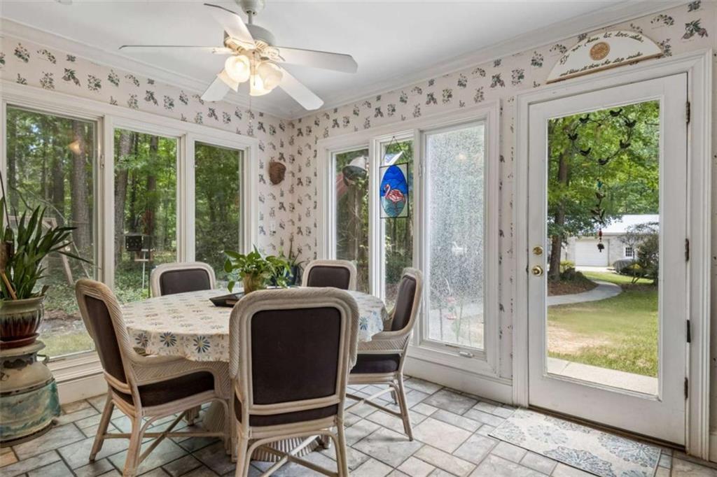 4751 Bill Cheek Road Auburn, GA 30011 - Photo 29 of 82 a view of a dining room with furniture large windows and wooden floor