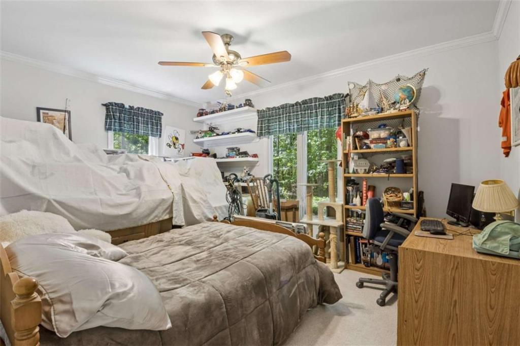4751 Bill Cheek Road Auburn, GA 30011 - Photo 38 of 82 a bedroom with a large bed and a chandelier