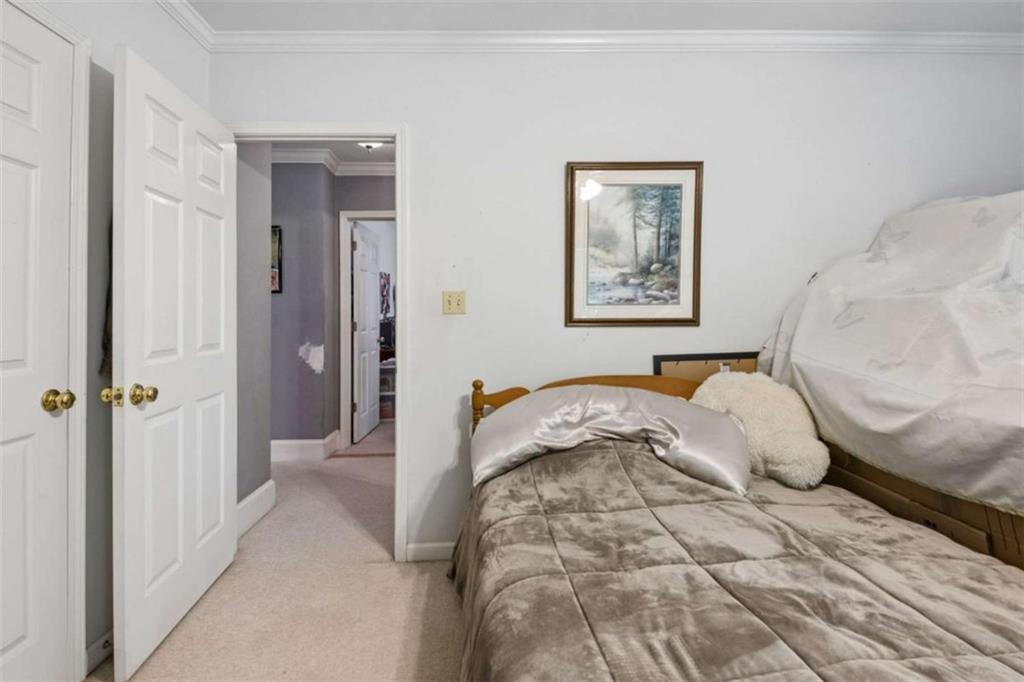 4751 Bill Cheek Road Auburn, GA 30011 - Photo 40 of 82 a bedroom with a bed and a painting on the wall