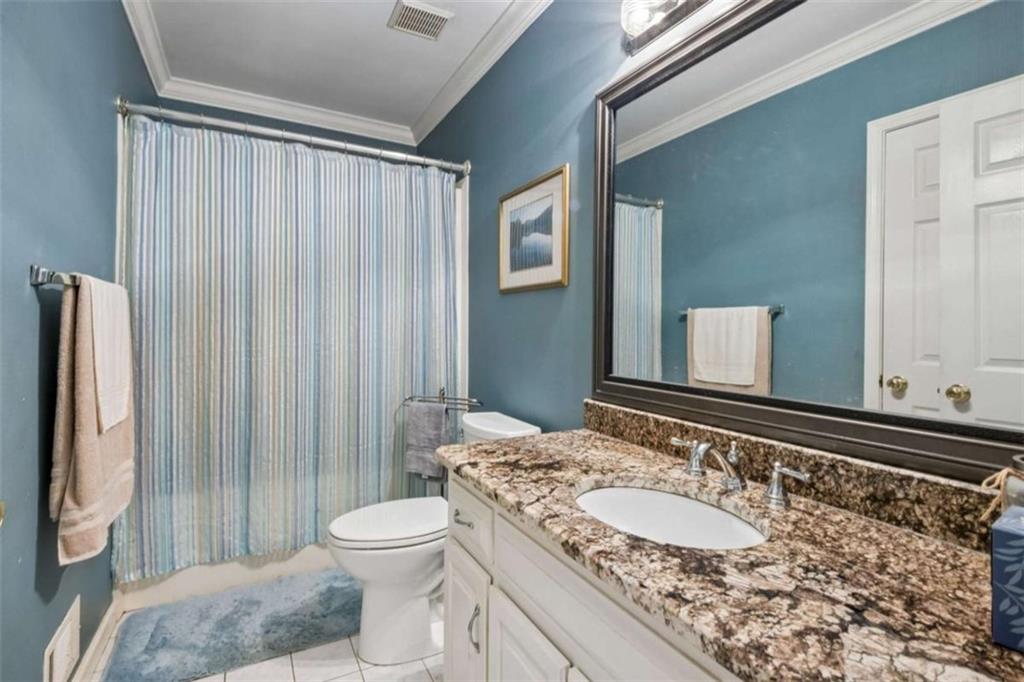 4751 Bill Cheek Road Auburn, GA 30011 - Photo 42 of 82 a bathroom with a granite countertop sink toilet and shower