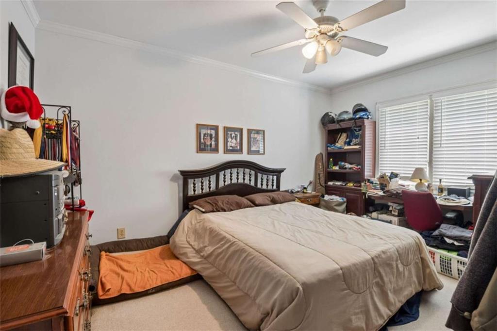 4751 Bill Cheek Road Auburn, GA 30011 - Photo 43 of 82 a bedroom with a bed and a chandelier