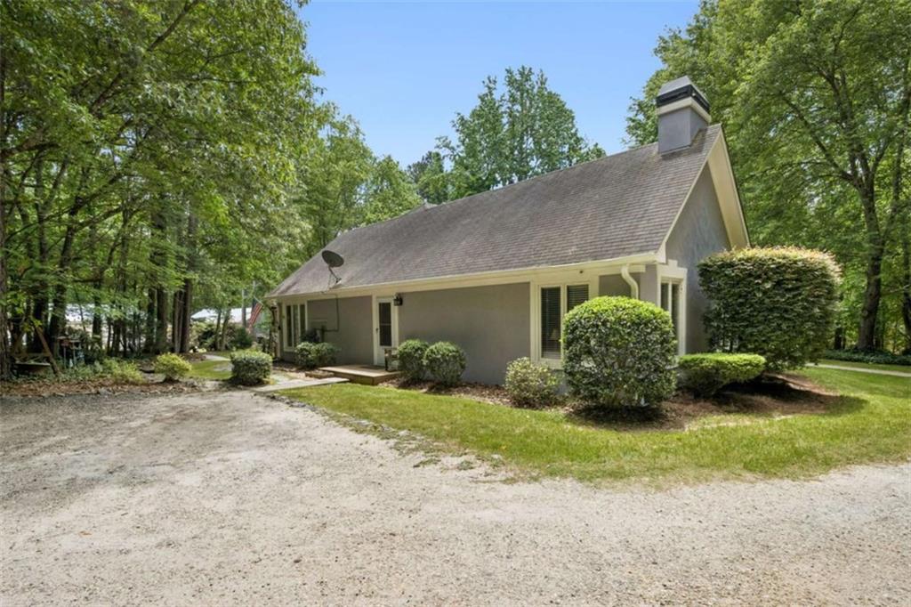 4751 Bill Cheek Road Auburn, GA 30011 - Photo 49 of 82 a view of a house with a yard and large tree