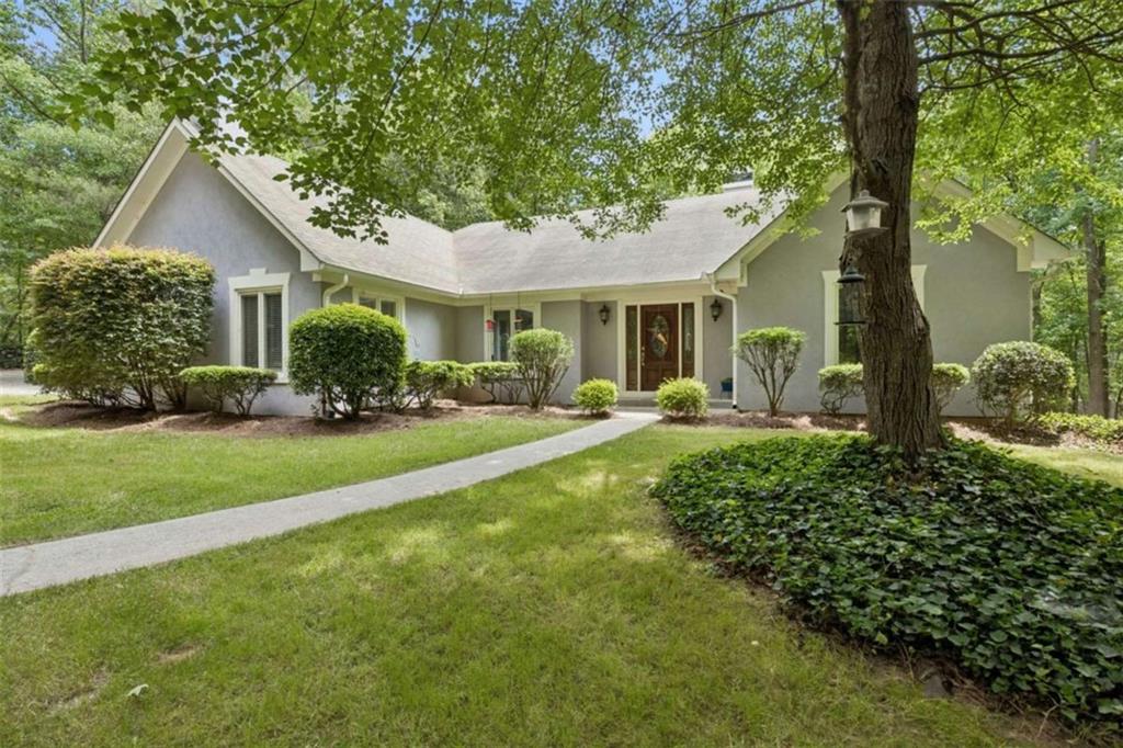 4751 Bill Cheek Road Auburn, GA 30011 - Photo 6 of 82 a front view of a house with a yard and potted plants