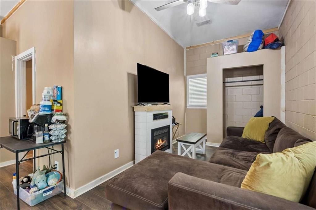 4751 Bill Cheek Road Auburn, GA 30011 - Photo 62 of 82 a living room with furniture and a flat screen tv