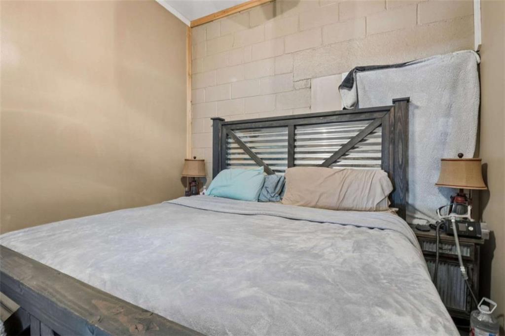 4751 Bill Cheek Road Auburn, GA 30011 - Photo 64 of 82 a bed sitting in a bedroom and chair