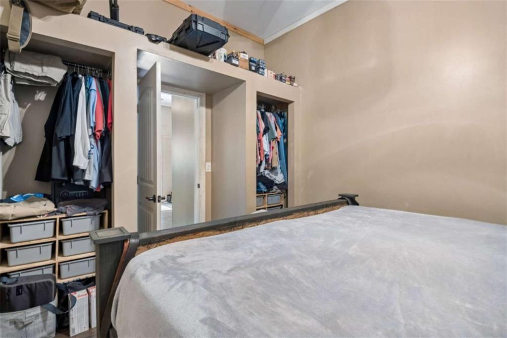 4751 Bill Cheek Road Auburn, GA 30011 - Photo 65 of 82 a bed room with a bed and a view of closet