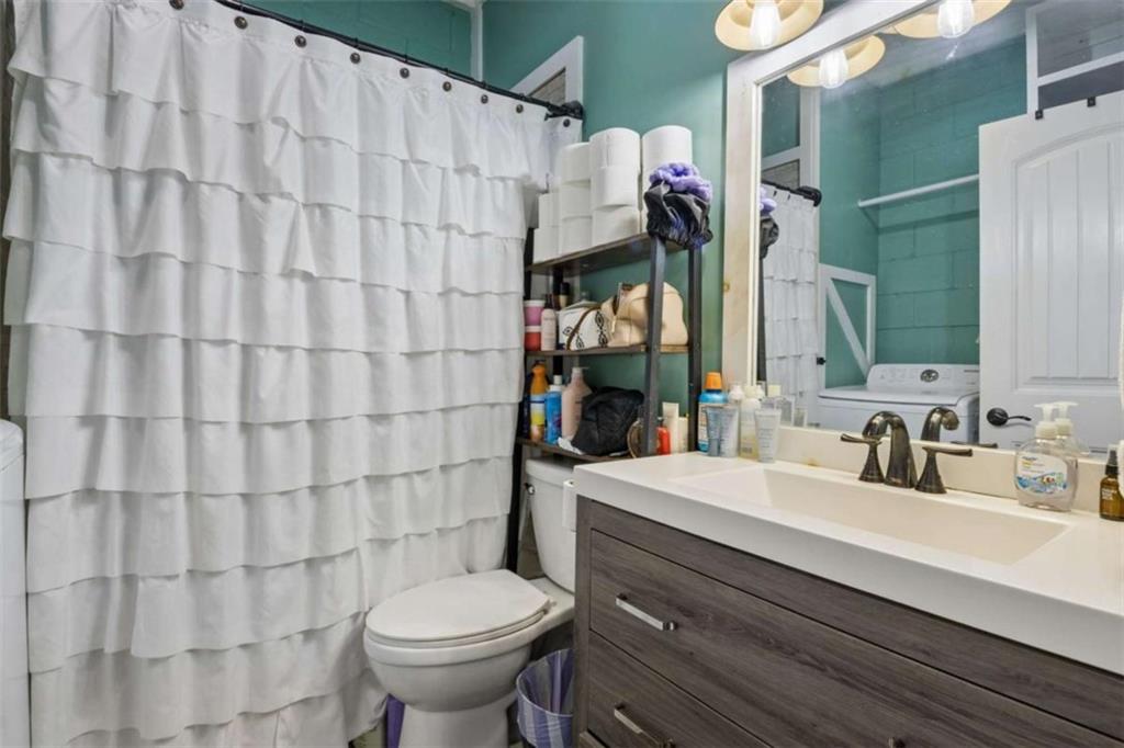 4751 Bill Cheek Road Auburn, GA 30011 - Photo 66 of 82 a bathroom with a sink a toilet and shower curtain
