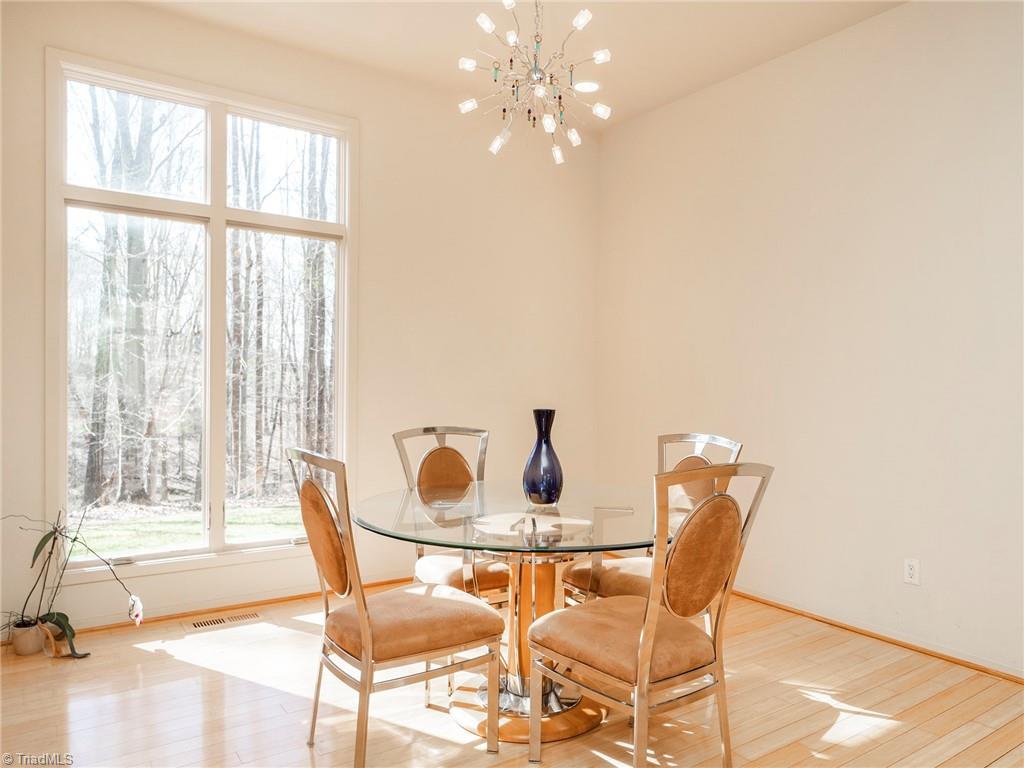 725 Hudson Road Summerfield, NC 27358 - Photo 16 of 36 Bright and airy dining area with bamboo floors.