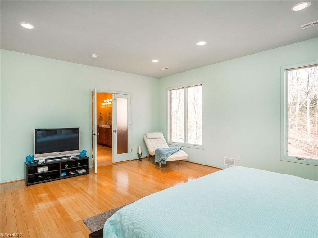 725 Hudson Road Summerfield, NC 27358 - Photo 17 of 36 Spacious primary bedroom with large primary bath.