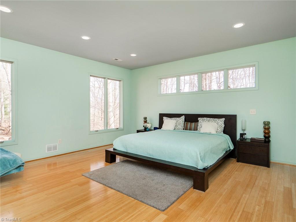 725 Hudson Road Summerfield, NC 27358 - Photo 6 of 36 Large spacious primary with bamboo floors, views of the backyard.