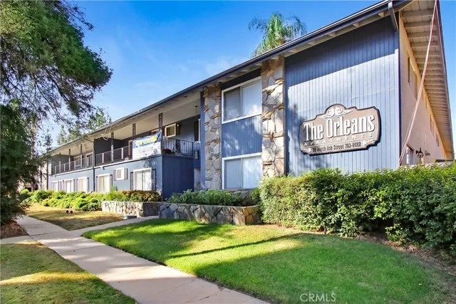a brick building with a yard in front of it