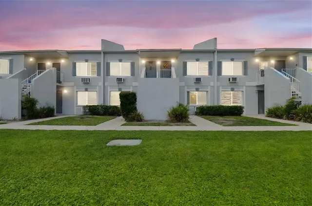 a front view of building with yard