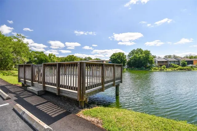 a front view of house with yard and lake view