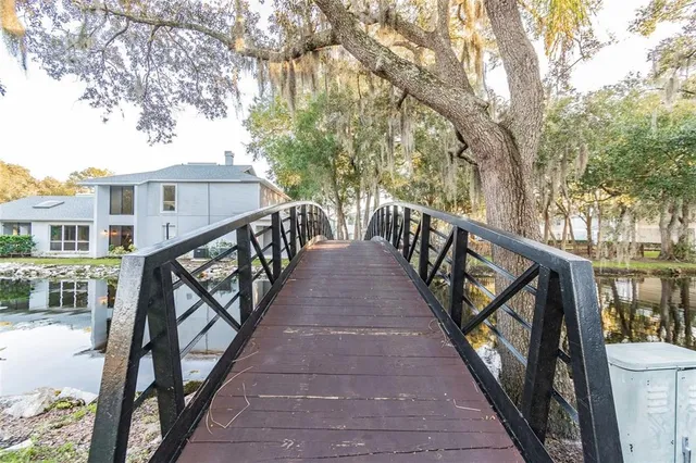 a view of an empty room with wooden floor and closet