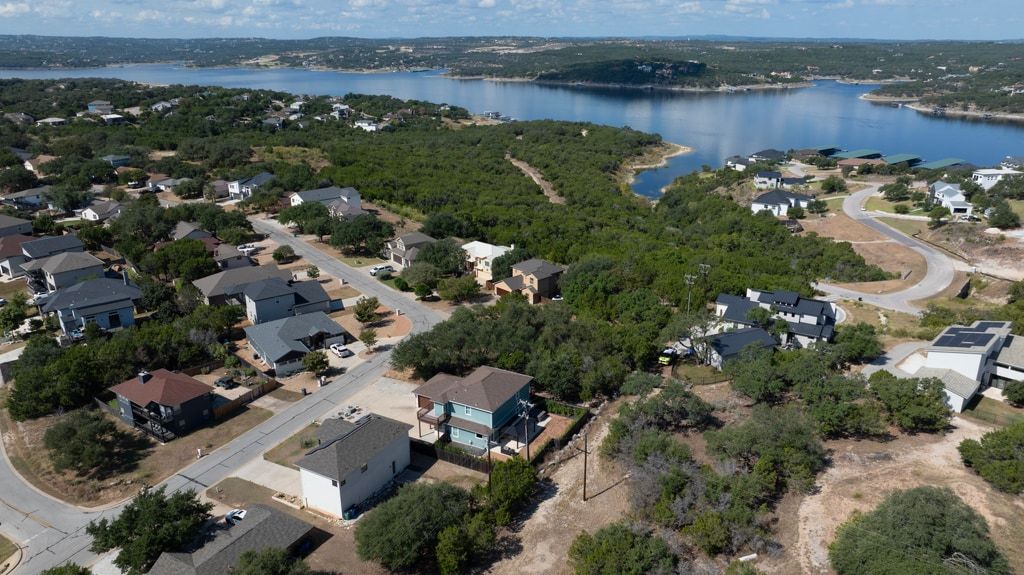 406 Summit Ridge Drive North Lago Vista, TX 78645 - Photo 21 of 25 an aerial view of lake and residential houses with outdoor space