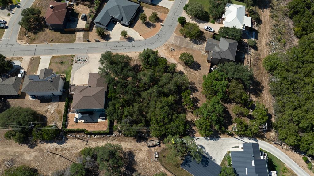 406 Summit Ridge Drive North Lago Vista, TX 78645 - Photo 23 of 25 an aerial view of multiple houses with yard