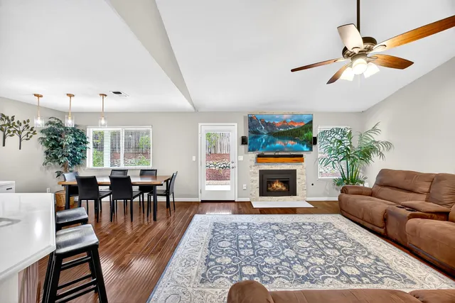 a living room with fireplace furniture and a flat screen tv