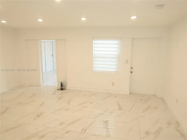 a view of an empty room with a window