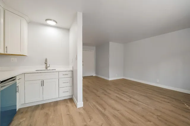 a kitchen with stainless steel appliances a refrigerator and a stove top oven