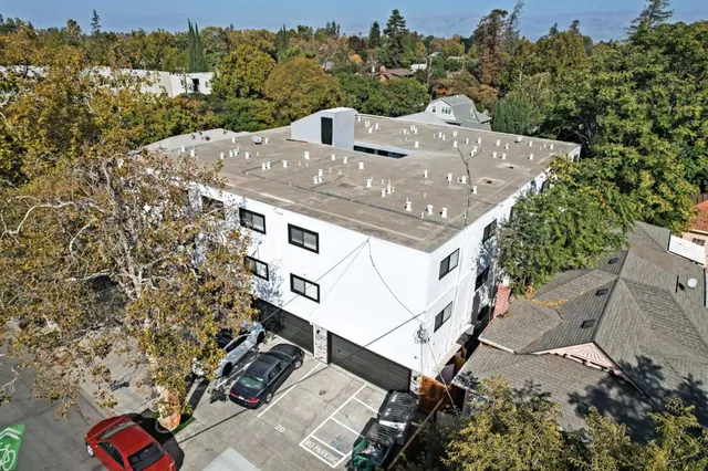 a kitchen with a refrigerator stove and wooden cabinets