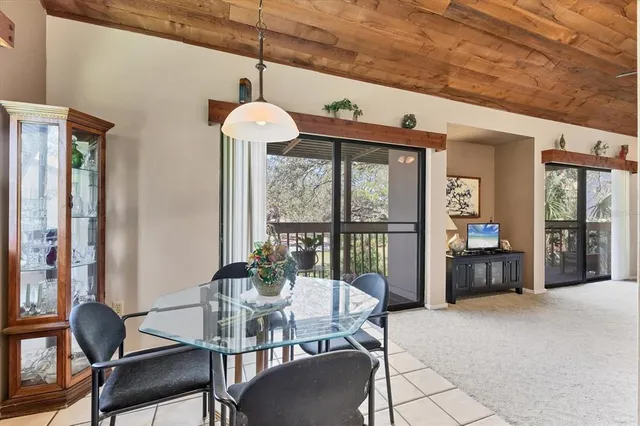 a view of a dining room with furniture wooden floor and a chandelier