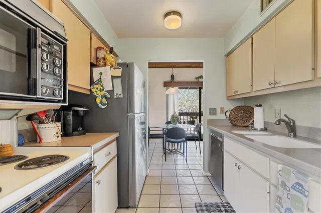 a kitchen with stainless steel appliances granite countertop a sink stove and cabinets