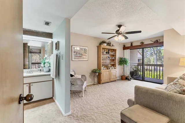 a living room with furniture and a floor to ceiling window