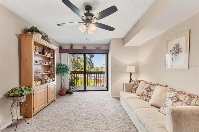 a living room with furniture large window and a chandelier