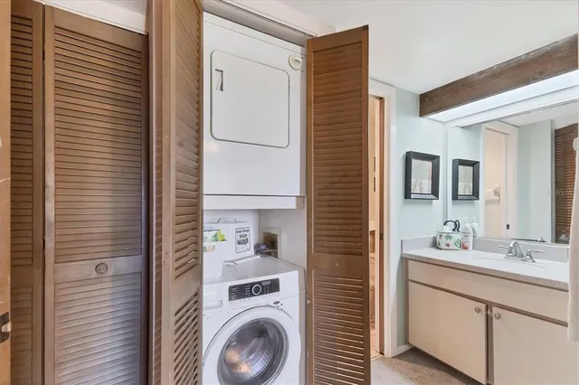 a bathroom with a sink a washer and dryer