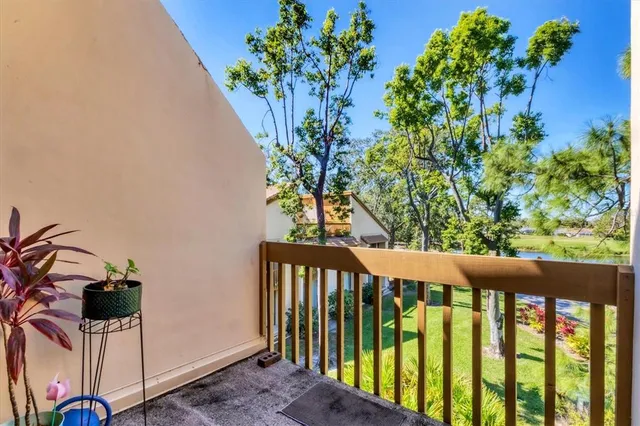 a view of a porch with a table and chairs