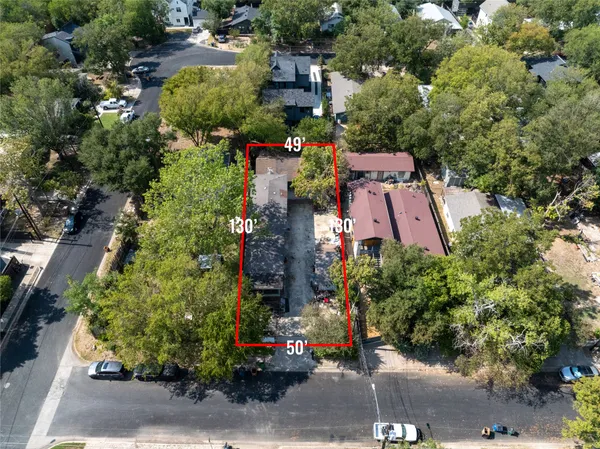 an aerial view of a house with a yard and garden