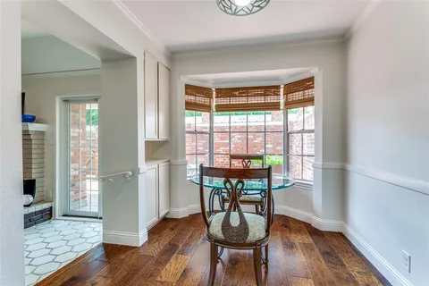 a dining room with furniture and wooden floor