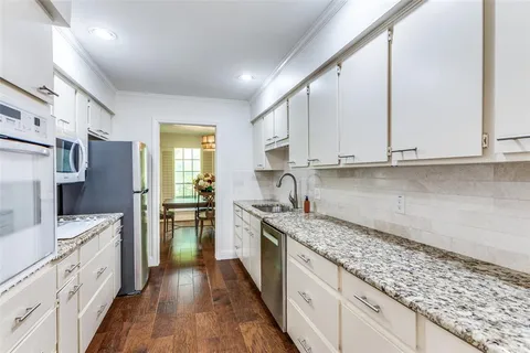 a kitchen with granite countertop cabinets stainless steel appliances a sink and a counter top space