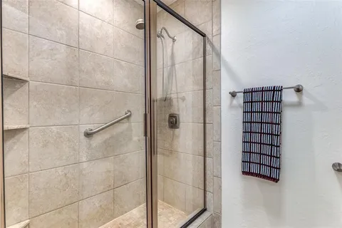 a bathroom with a shower and a sink