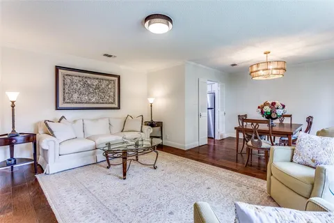 a living room with furniture and a dining table