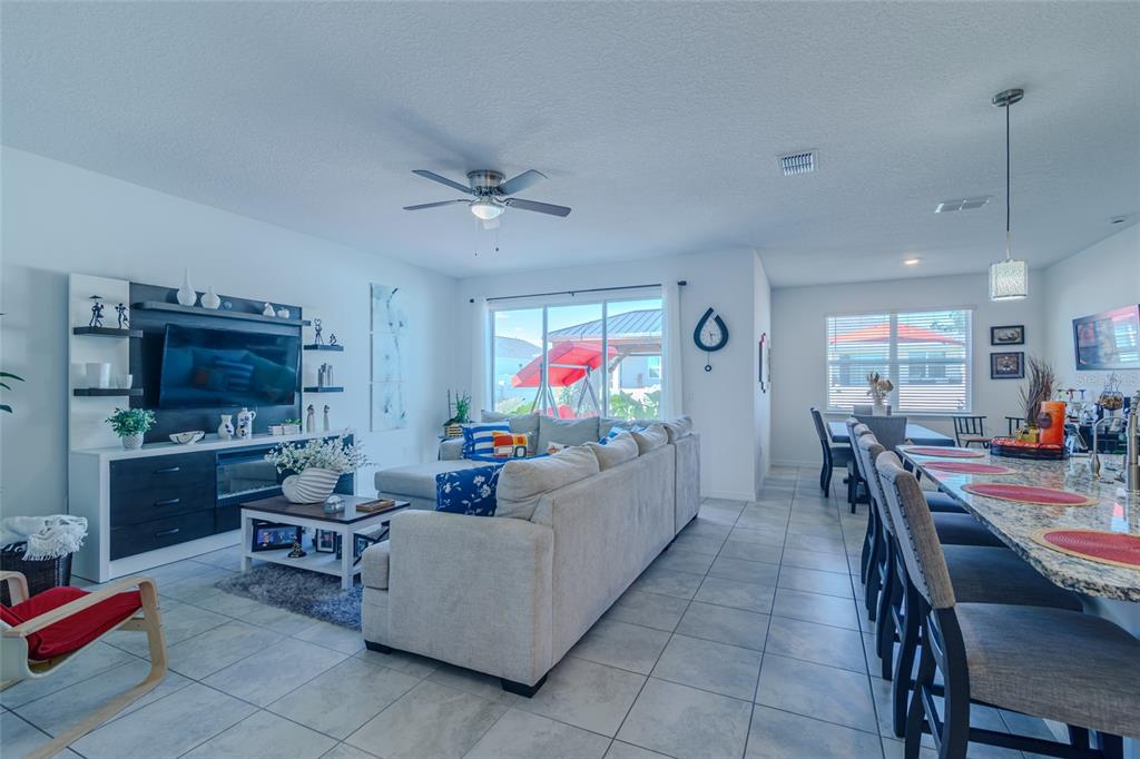 7095 Southwest 61st Place Ocala, FL 34474 - Photo 12 of 61 a living room with furniture and a flat screen tv