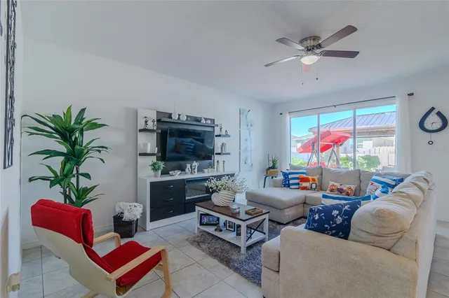 a view of kitchen island with stainless steel appliances table chairs and living room