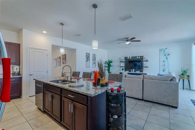 a kitchen with stainless steel appliances granite countertop a sink refrigerator and cabinets