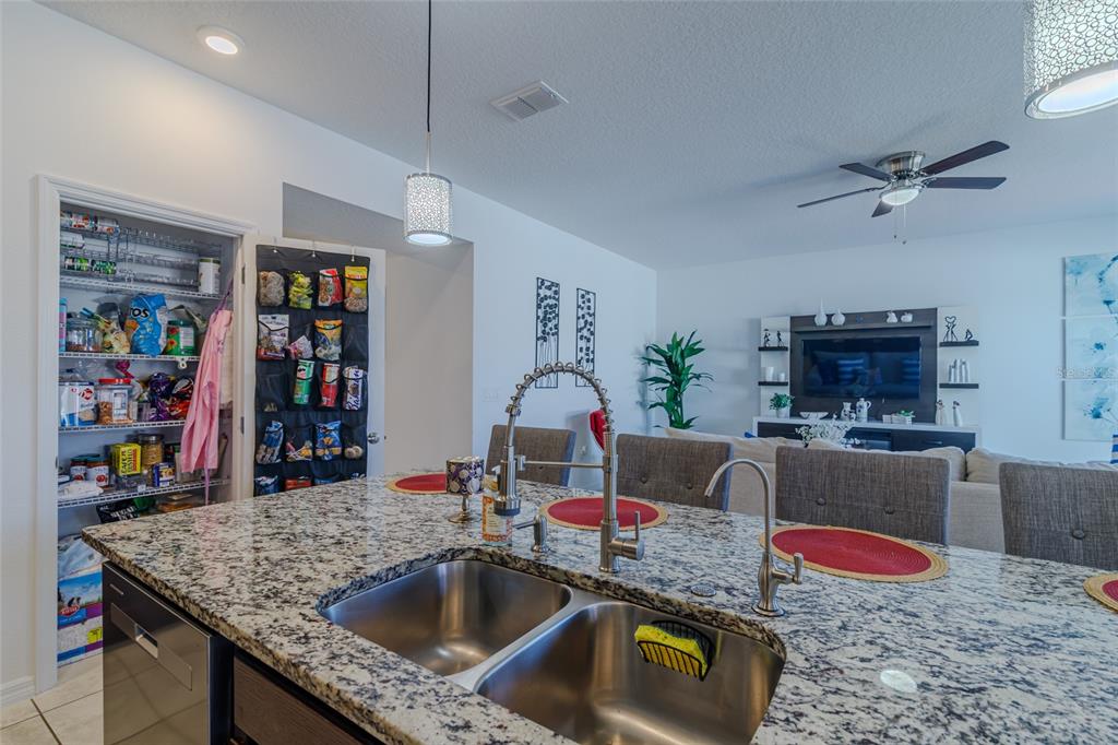 7095 Southwest 61st Place Ocala, FL 34474 - Photo 22 of 61 a kitchen with kitchen island stainless steel appliances granite countertop a sink and a refrigerator