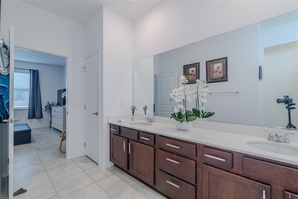 7095 Southwest 61st Place Ocala, FL 34474 - Photo 31 of 61 a spacious bathroom with a granite countertop sink and a mirror