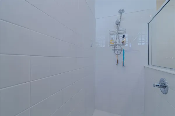 a bathroom with a sink vanity and a shower