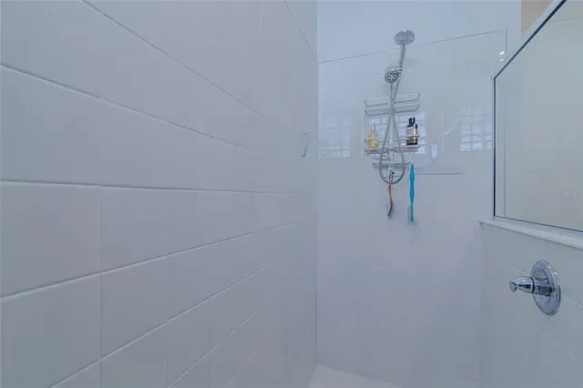 a bathroom with a sink vanity and a shower