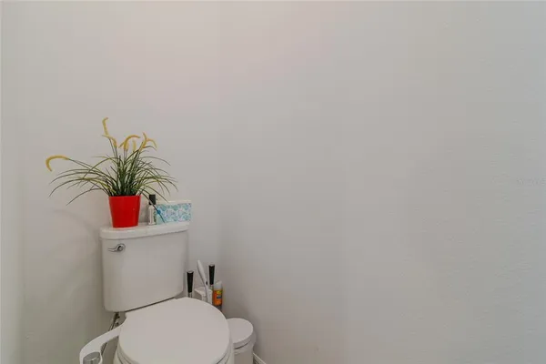 a bathroom with a sink vanity mirror and toilet
